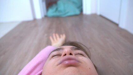 Someone is dragging a sleeping and loudly snoring man across the floor. A prank on the husband