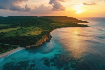 Fototapeta premium Aerial view of sunset over tropical coast, beach, and ocean.