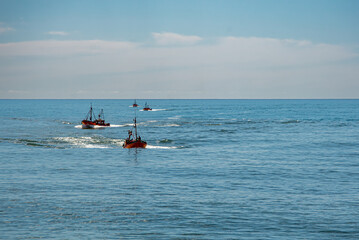Fototapeta premium a fleet of small fishing boats sailing off the coast of Mar del Plata