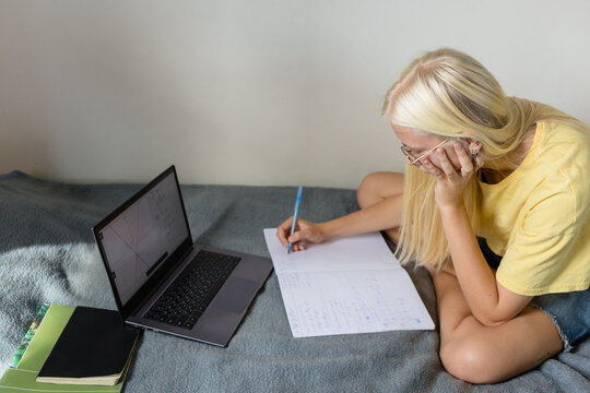 Schoolgirl doing homework in comfort