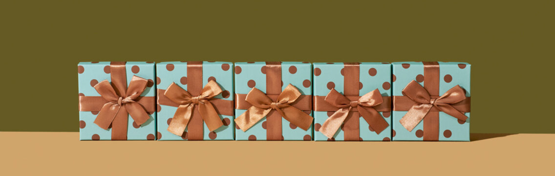 gift boxes tied with golden ribbons, panoramic format