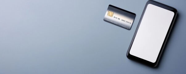 mobile payment integration concept. Smartphone and credit card on a gray background, ideal for digital finance concepts.