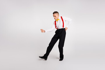 Elegant young dancer in formal attire showcasing dynamic choreography on a white background with...