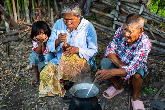 Elderly Thai Couple Cooking with Granddaughter in Rural Thailand