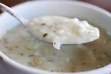 A Delicious Creamy White Soup with a Spoon in Sharp Focus for Tasting