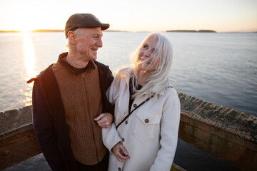 Happy Senior Couple Enjoying a Sunset by the Ocean