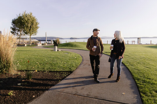 Senior Couple Enjoying Coffee Walk in Scenic City Park