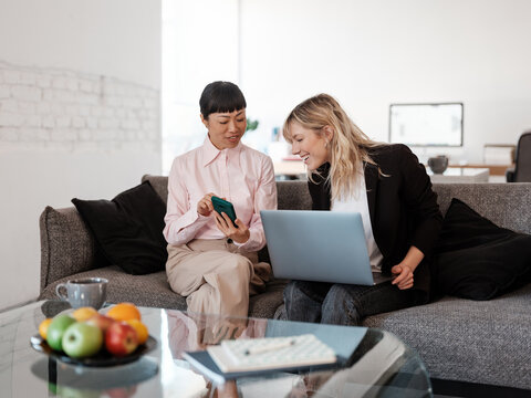 Two Women Collaborating on Projects in a Modern Office Space