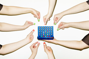 People playing Connect Four game. Cooperation, teamwork and strategy