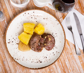 Baked pork pieces with potatoes in goulash closeup