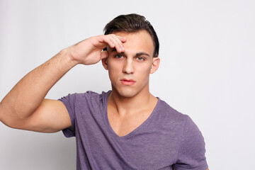 Handsome young man on grey background looking at camera