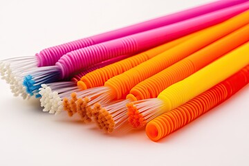 Pack of silicone reusable straws with cleaning brushes placed on white.
