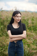 Beautiful women taking photos in the grassland wetland park in midsummer