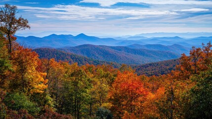 A breathtaking view of rugged mountain peaks in the distance, with vibrant autumn colors on the trees in the foreground.