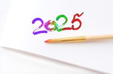 Painted 2025, new year on white, colorful text, number 2025 and lipstick kiss. Happy New Year,...