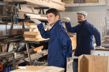 Two funny sawmill workers perform various funny acrobatic moves