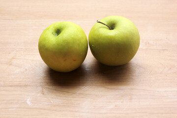 green apples on wooden table