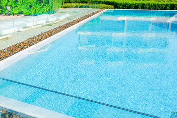Empty swimming pool with sunbed and white umbrella in resort hotel for vacation leisure and white sand,resort neary sea and beach in summer..