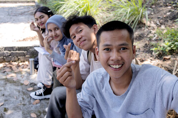 POV of Multiethnic Group Of Young Students Taking Selfie Together Outdoor	