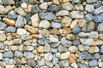 Modern Privacy Fence of Natural Rock Gabions, Walls made of stone and iron Made by welding steel into a sieve and then put the stone in the middle,style of hotel or office Building,Selective focus.