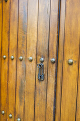 Close up of old Key in wooden door at home, Brown Wood Front Door with Ornate Brass Skeleton Key,copy space..