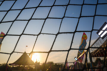 Silhouette of trampoline net with sunset background