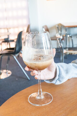 Young girl holding glass of Cold Mocktail on table,female hand swirling red wine in wine glass,Friends cheering with wineglasses.