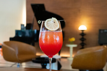 Premium Alcoholic Cocktail with blurred music band as background,Pleasant Evening In Respectable...