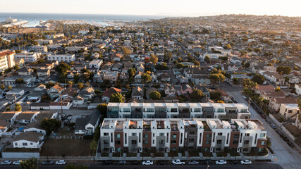 San Pedro, Los Angeles, California, USA - November 12, 2024: Sunset light shines on housing in...