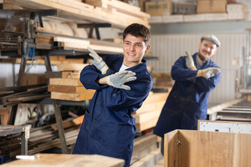 Two funny sawmill workers perform various funny acrobatic moves