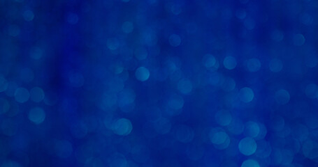 Blurred glow. Blinking blue. Decorative festive background with color flare particles glittery flickering rays delicate atmosphere.