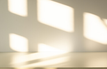 Wall interior background, studio and backdrops show products. with leaf shadow from window color beige and white. background for text insertion and presentation of product	