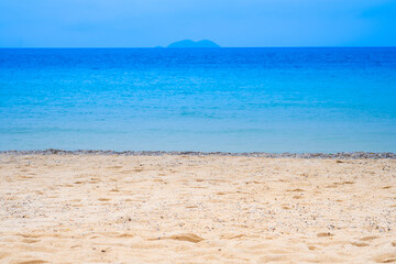 Nature of the beach and sea Summer with sunshine, sandy beaches, clear blue waters sparkling against the blue sky. On an island with good ecology and environment Background for summer vacation concept