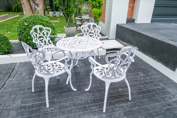 Classic white steel chair and table in the garden,empty white vintage chairs in the garden,decoration english garden concept.
