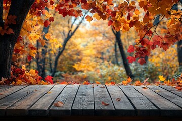 The empty wooden table top with blur background of autumn Maple leaves. Exuberant image
