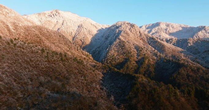 Beautiful aerial landscape of winter snowy mountain in the morning sunrise sunshine at Xiling Snow Mountain of Sichuan China