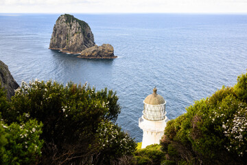 View of Cape Brett Lighthouse and Piercy Island, also known as The “Hole in the Rock”. Bay of...