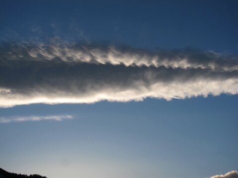 Atmospheric gravity waves clouds, breaking waves over Flatirons Boulder in the evening, Colorado