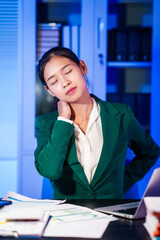 Asian business women often work late into the night, overwhelmed with stress, headaches, and...
