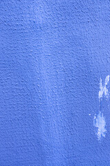 Unfinished blue plaster on the wall.