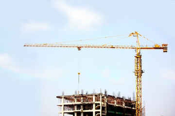 Construction cranes are constructing tall buildings on site.