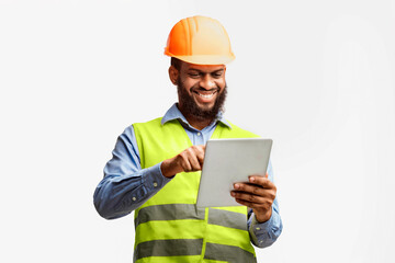 Architect Using Digital Tablet Working On Construction Site Checking Building Project Standing On White Studio Background.