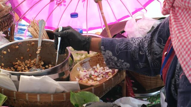Making Miang Kham (traditional Southeast Asian herbal snack from Thailand and Laos), Traditional Thai snack. It&rsquo;s a snack containing different ingredients of herbs and vegetables. 