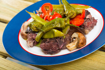 Tasty lamb meat braised in red wine with vegetables, Provencal herbs and smoked paprika