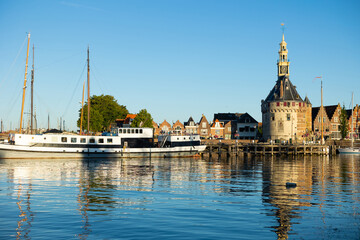 View of Hoofdtoren from lakeside on northwestern shore of Markermeer, Netherlands. Tower beside quay in Hoorn.