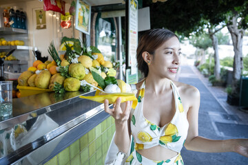 Obraz premium Fresh from farm woman grab yellow lemon sorbet gelato in Capri, Italy.