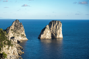 Aerial view of beautiful coastal cliffs  faraglioni di mezzo in Capri Island, Italy.