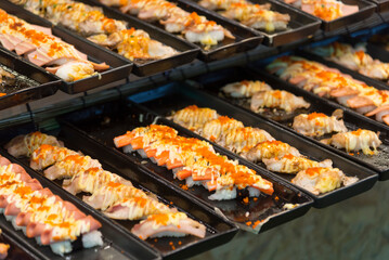 Closeup focus to row of sushi menu  in the tray