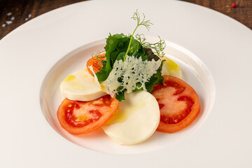 Tomato and mozzarella salad on a white porcelain plate, Caprese Salad