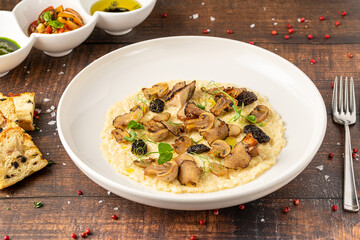 Porcini mushroom risotto in a white porcelain plate, risotto ai funghi porcini